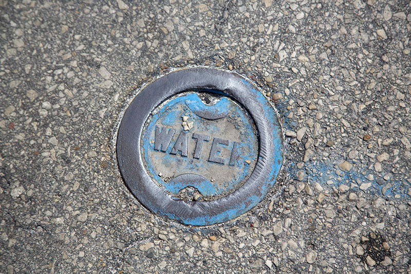 A picture of a storm water drain in the road 