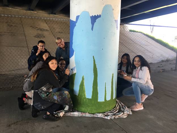 AMS students woking on the mural