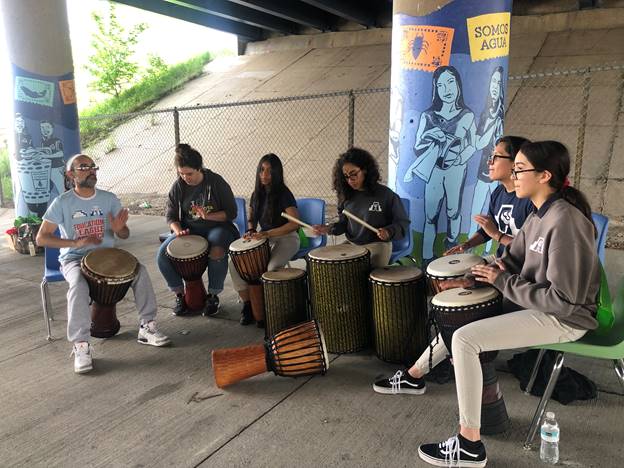 Celebrating the completed mural with Latino Arts Inc. drumming instructor Cecilio Negron and some of the students
