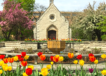 St. Joan of Arc Chapel with tulips blooming in front. 