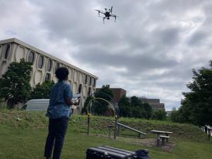 Undergraduate student Aminata Ndiaye flying a drone