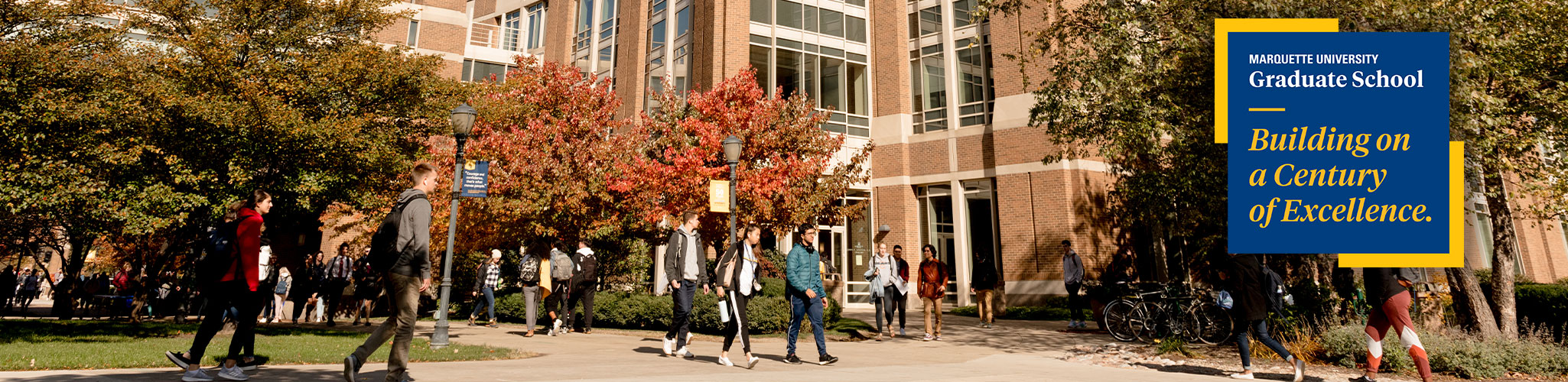 Many students walking in front of Reynor Memorial Library.
