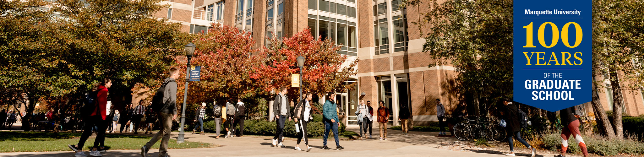 Many students walking in front of Memorial Library.