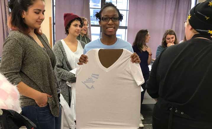 Marquette Art Club students displaying t-shirt