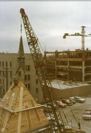 A crane places the steeple on the St. Joan of Arc Chapel, 1966.
