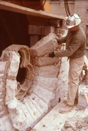 Workman setting stones as a part of the St. Joan of Arc Chapel's reconstruction on the Marquette University campus, circa 1966.