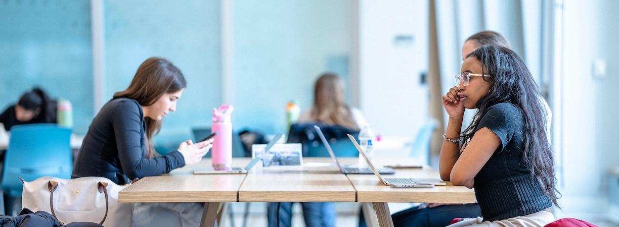 Students collaborating at one of the picnic tables within the Lemonis Center