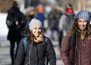Two students on campus in winter
