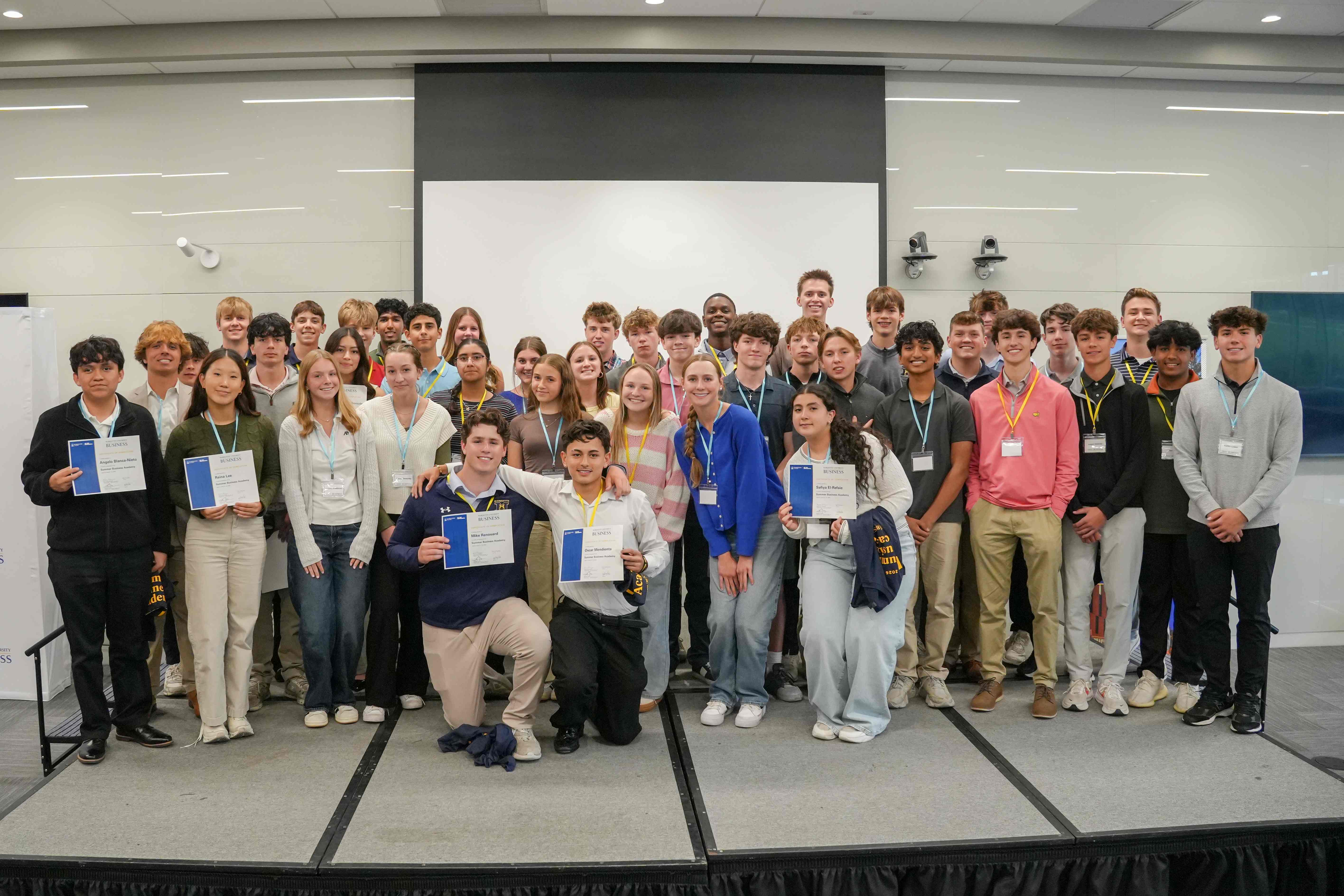 students pose with certificates