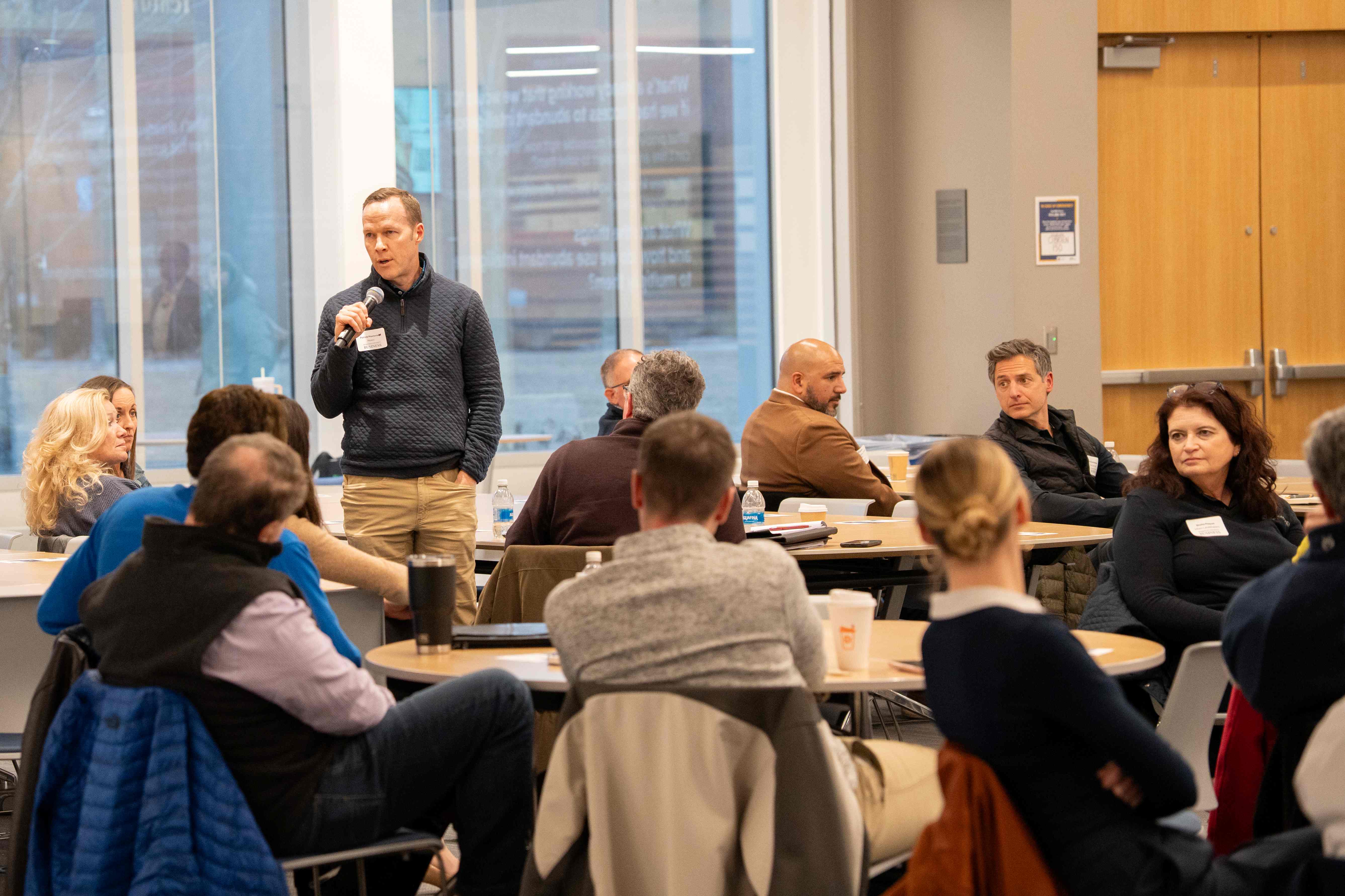 professional speaks to business leaders about ethical AI use