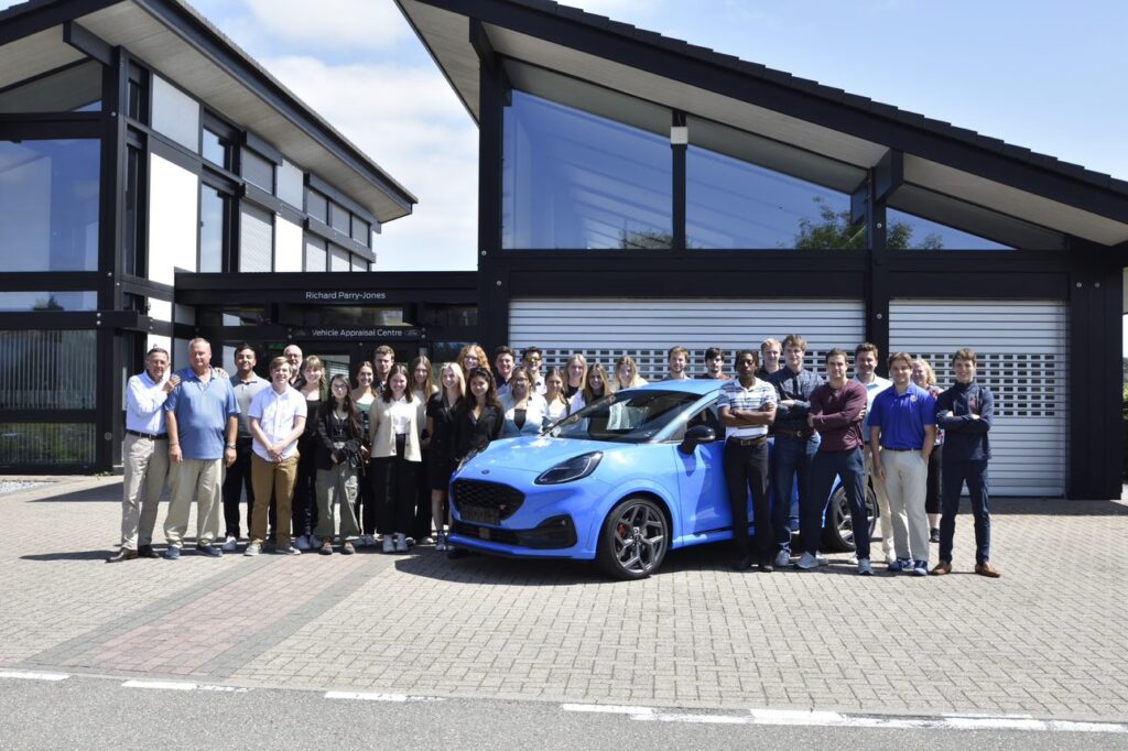 Undergraduate students pose at the Ford Proving Ground in Belgium.