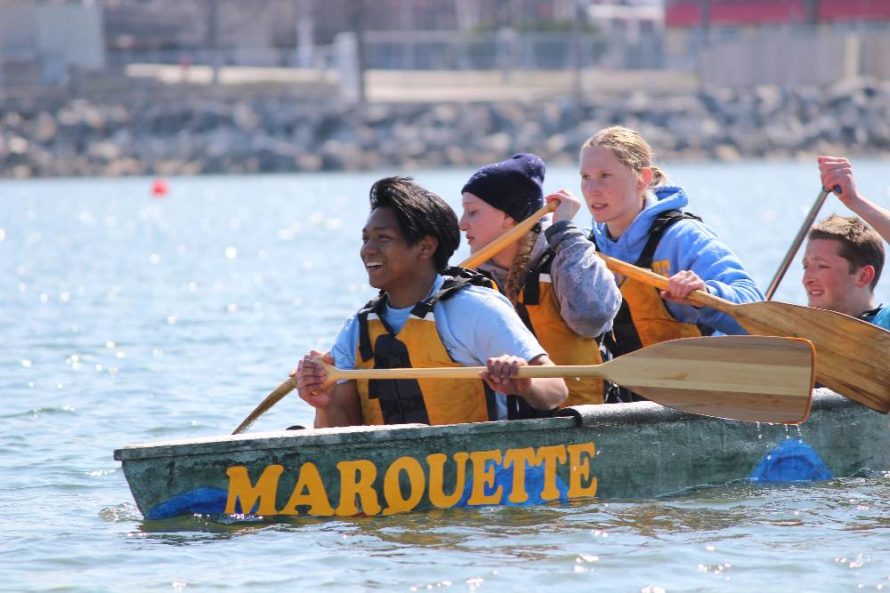 Students rowing a boat made of concrete