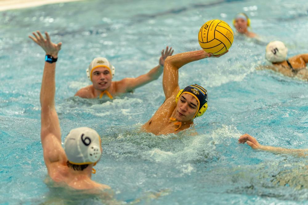 A student water polo player about to throw a ball