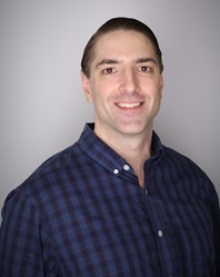 Michael poses for a professional headshot