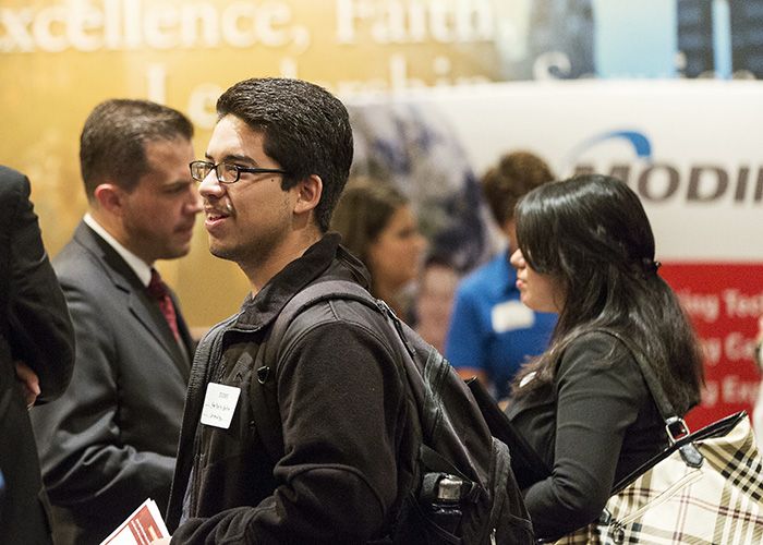Student interacting with an employer at a career fair