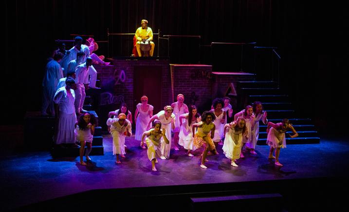 Students performing on a theatre stage