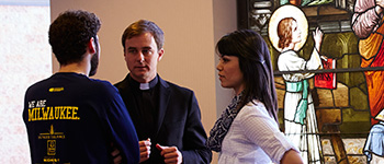 Students talk to Jesuit