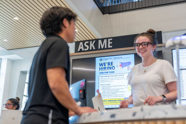 A student attends to the Ask Me Desk