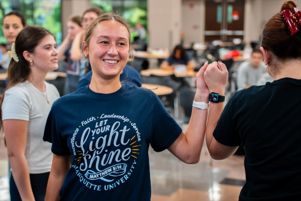 Students high five during a Mission Week event