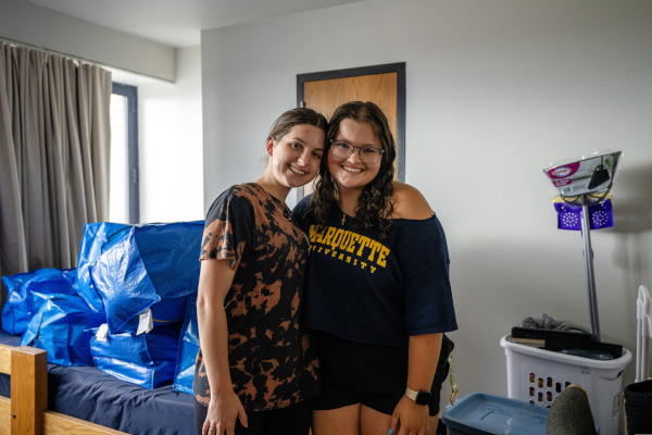 Two students pose after moving into their new residence hall.