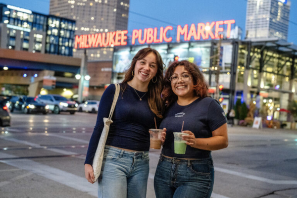 Two students stand in front of the Milwaukee Public Market