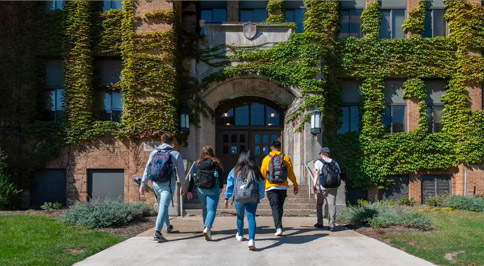 Students walking toward the doors of Marquette Hall