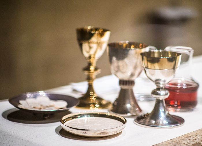 Chalices, bread and wine on an altar