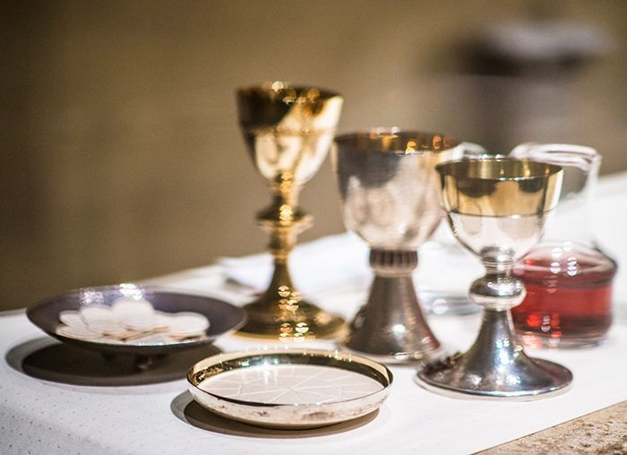 Chalices, bread and wine on an altar               