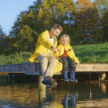 Father fishing with daughter
