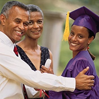 Parents congratulating daughter on graduation day