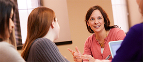 Education Graduate students discussing in a classroom on Marquette University campus