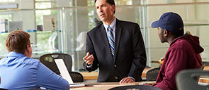 Professor with three students having a discussion