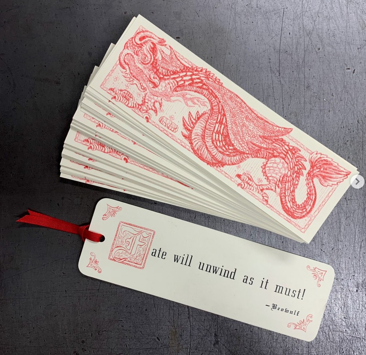 A bookmark with text and a dragon