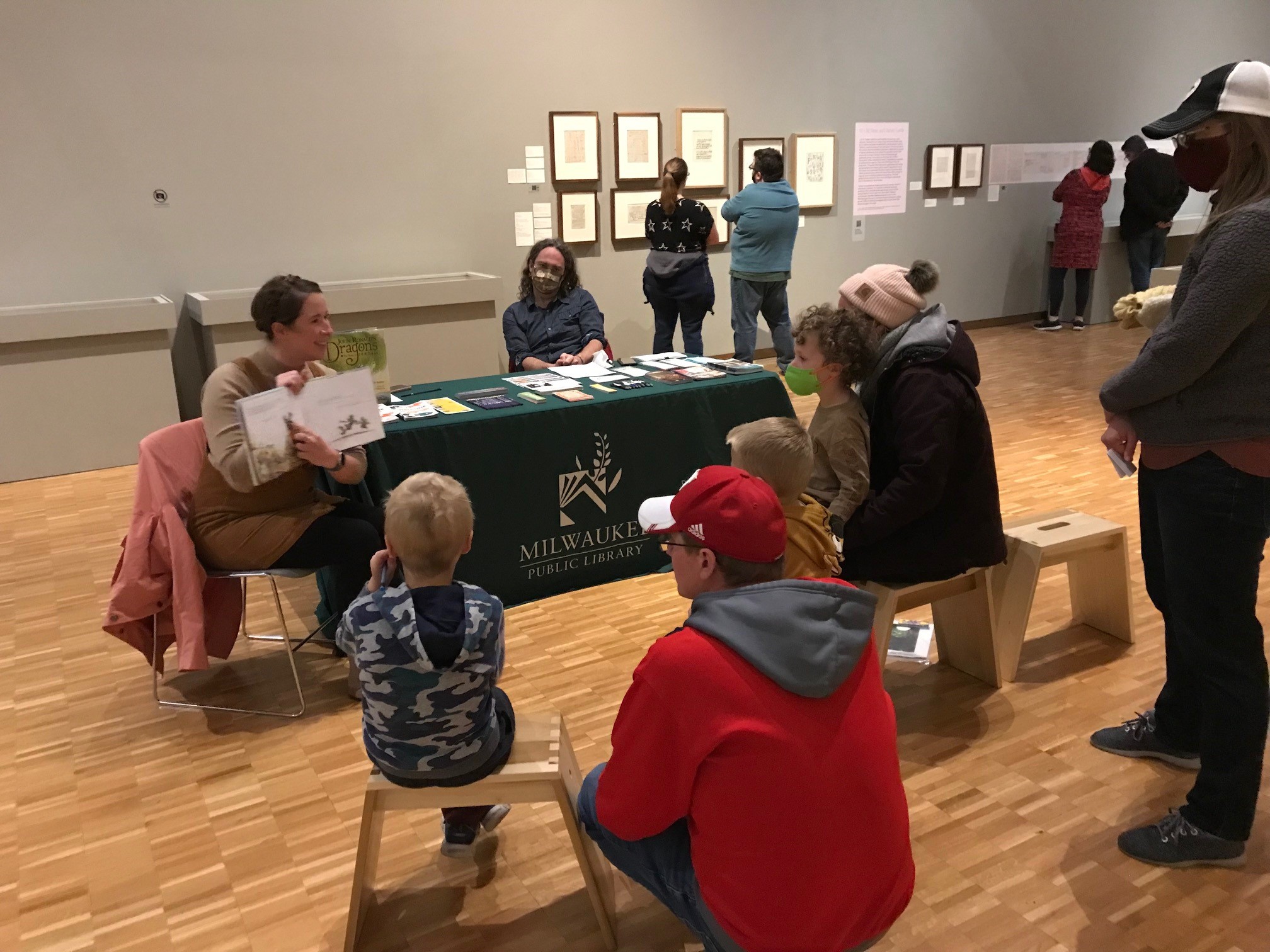 Milwaukee Public Library staff reading a story to children inside the museum
