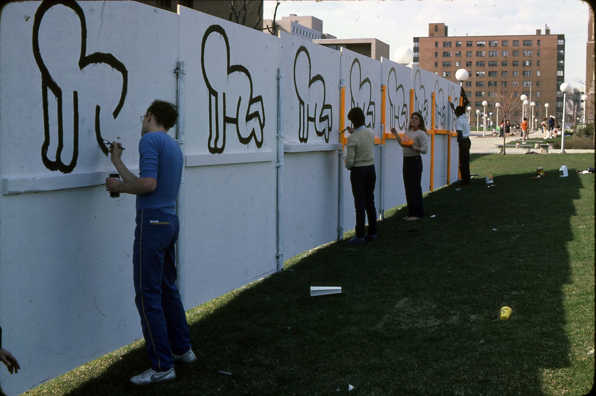 Keith Haring painting the fence at the Haggerty