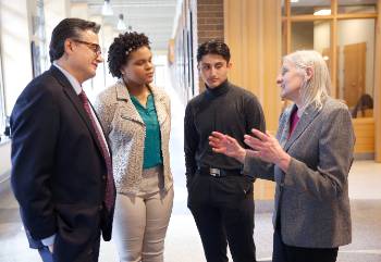 Pedro Colon (former member of the Wisconsin State Assembly), Professor Karen Hoffman (Coordinator of the Les Aspin and Kleczka Program) and interns discussing how to network in Zilber Hall.