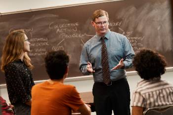 Professor Lowell Barrington instructing students in class.