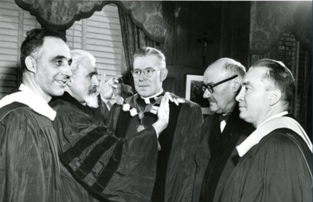 archival black-and-white image of Slavic Institute faculty giving an award to the Marquette president
