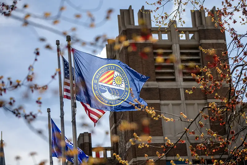 Marquette flag outside of Raynor Library
