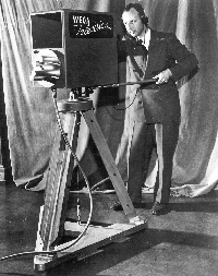 Student operating a floor camera in the Television studio