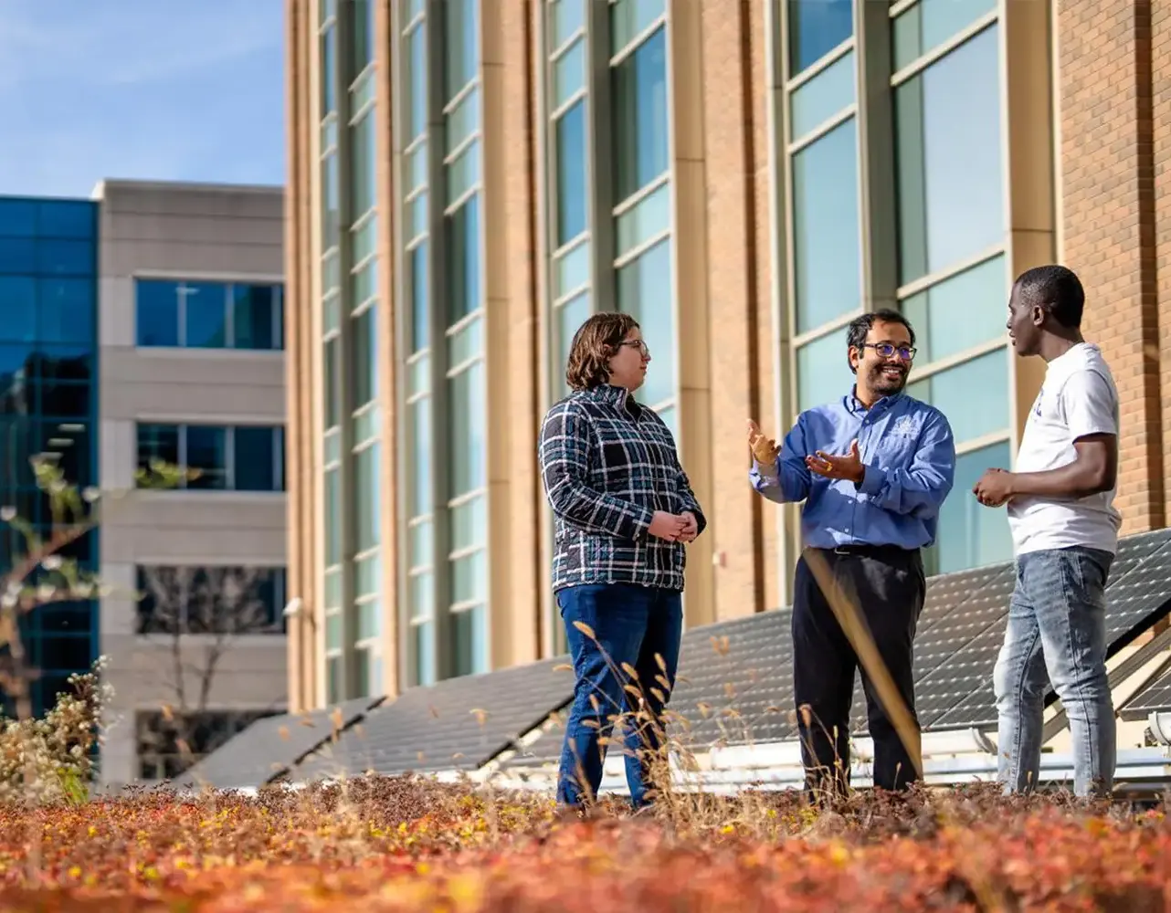 Faculty standing outside
