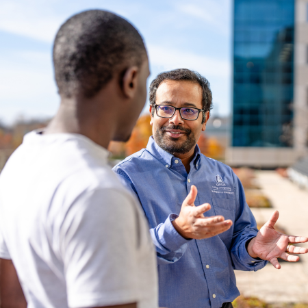 graduate student mentorship faculty member talking to a student outside
