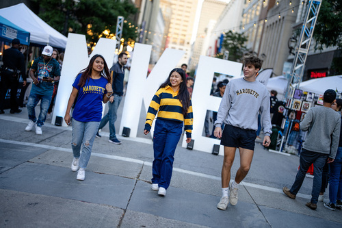 marquette student walks in urban setting in milwaukee