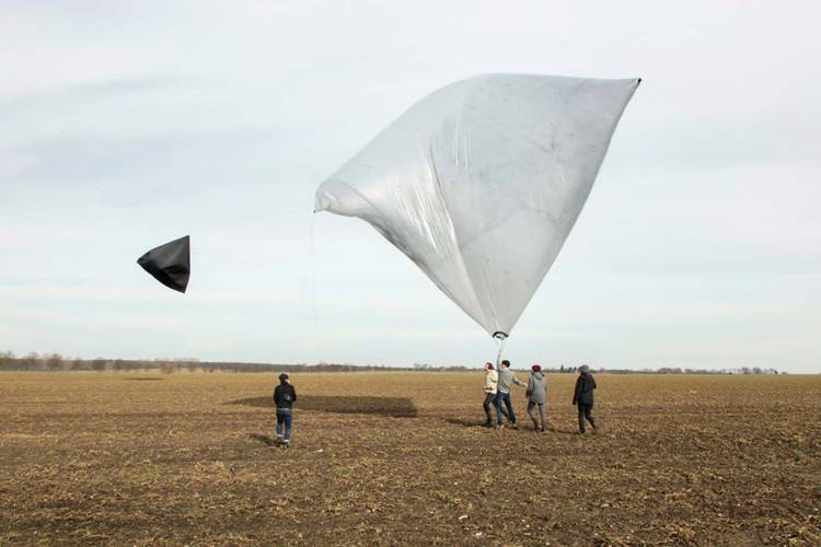 Tomás Saraceno, “Aerocene PM2.5” (2015), launched in Schönfelde, Germany, March 4, 2017; inkjet print (2022), 24 x 16 1/8 inches, photo print of “Aerocene PM2.5” sculpture comprised of 240 cubic meters of air, ETFE foil, PM2.5, sun, air, and wind after takeoff (image courtesy the artist and Tanya Bonakdar Gallery, New York/Los Angeles), on display at the Haggerty Museum of Art.