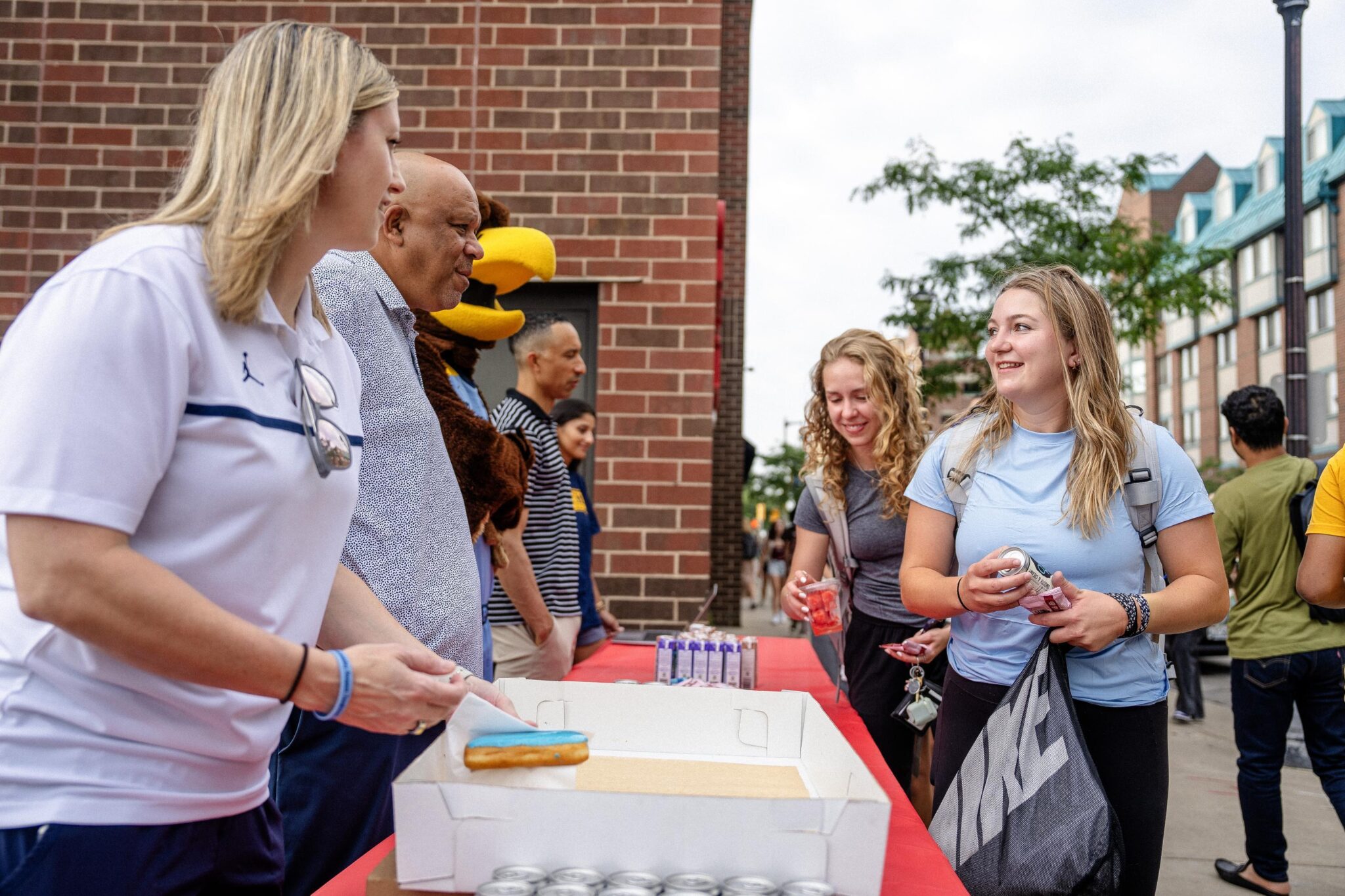 MU President, Basketball coaches handing out breakfasts in 2024
