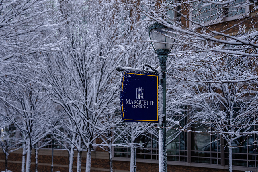 A lamppost sign on the Marquette University campus