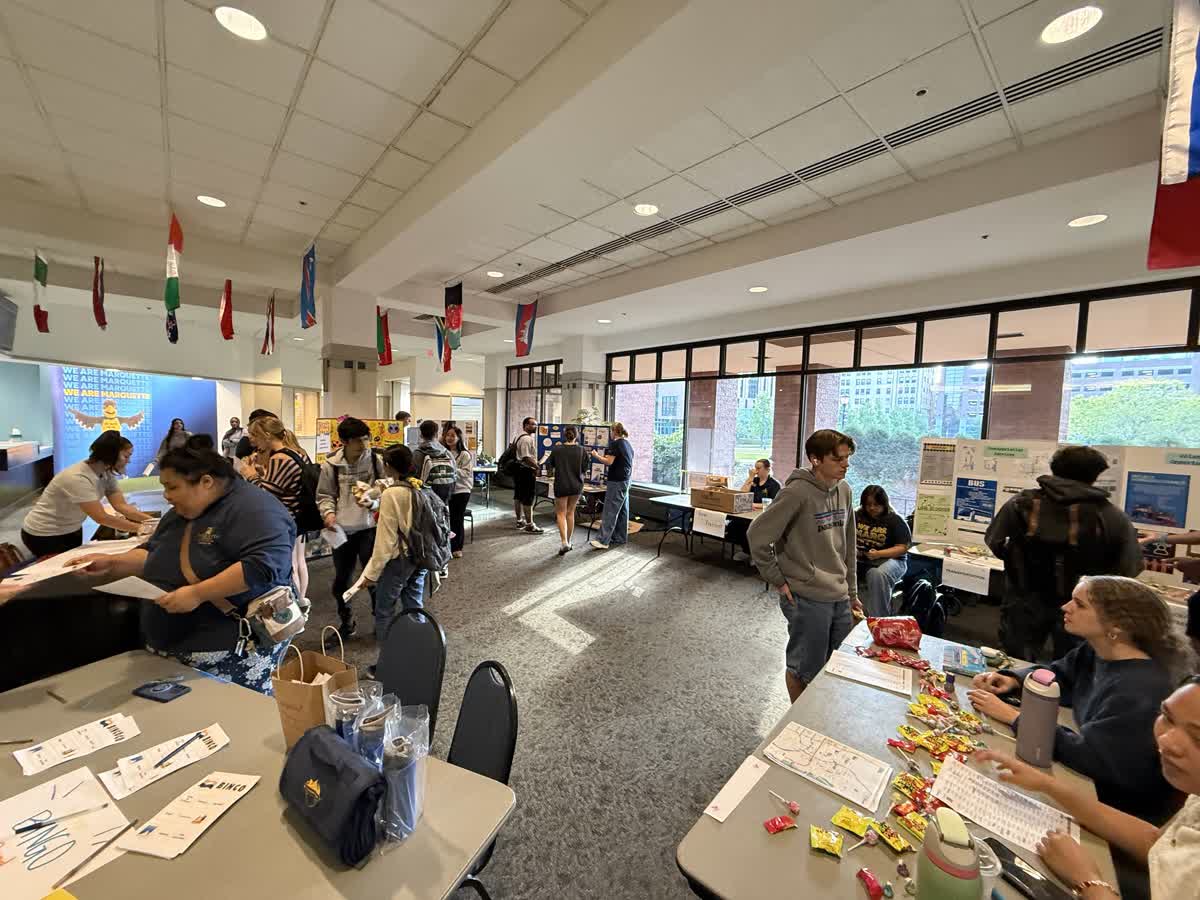 group of college students visiting information tables