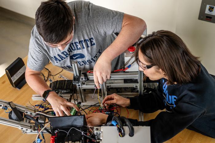 Engineering students working on robot