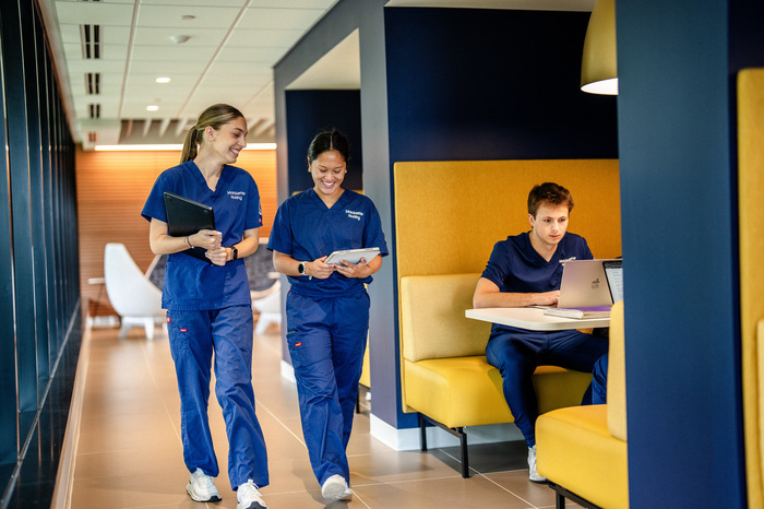 Nursing students walking through common area