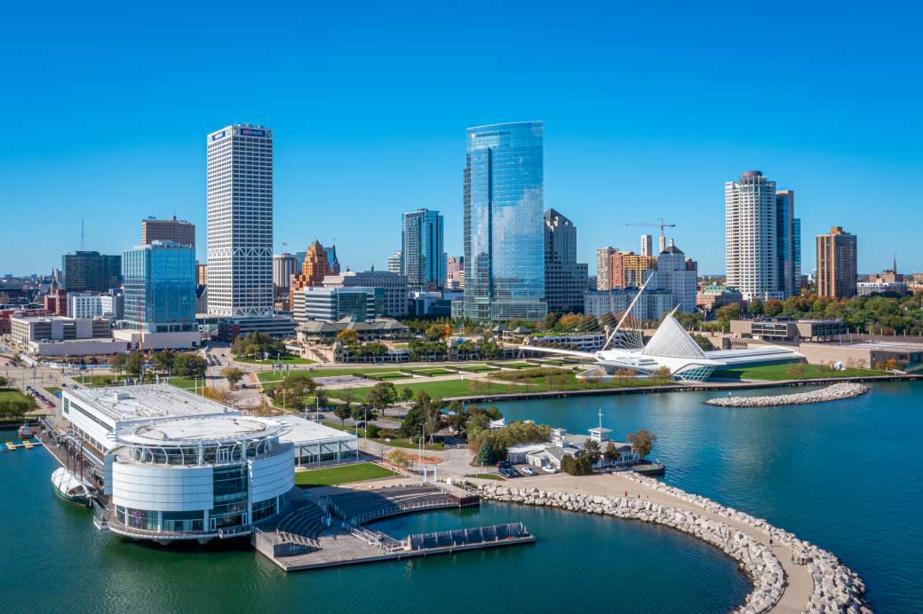 Aerial take of Milwaukee's skyline highlighting Milwaukee's iconic buildings and museums facing Lake Michigan